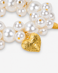 Chunky ivory pearl statement bracelet featuring textured heart charms with a polished Gold tone finish.