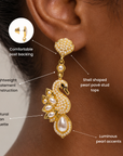 Luxury swan drop earrings featuring sparkling crystals, dimensional ivory pearls, and polished gold tone detailing.