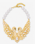 Anastasia Swan Statement Hinge Bib featuring two crystal encrusted gold swans, luminous pearl details, and dramatic outstretched wings.