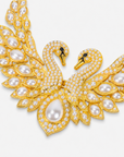 Anastasia statement necklace designed with two graceful swans, shimmering crystal accents, sculptural wings, and luminous ivory pearls.