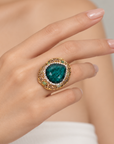 Sassy Jones Armana Emerald ring with a rich green stone centerpiece and dimensional embellished setting.