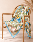 Oversized floral scarf featuring pink, blue and sage green bows layered over ornate porcelain inspired patterns.
