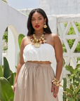 Statement charm necklace featuring pearl-studded shell pendants, coral accents, starfish charms, seashell details, pavé crystal elements, and gold-tone hardware by Sassy Jones.