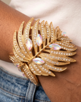 Front view of Calypso Palm Crystal Adjustable Cuff with sweeping tropical leaves and multicolor reflective gemstones.