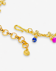 Cherish Hummingbird 18k Garden Necklace displayed flat featuring colorful enamel birds, floral charms and an adjustable gold chain.