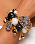 Black and gold statement bracelet featuring chunky round beads, natural agate, and dangling bead clusters.