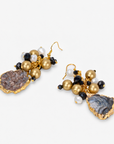 Black and gold statement earrings featuring natural sliced agate drops and faceted bead clusters.