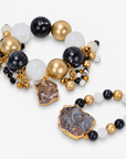Black and gold statement bracelet featuring chunky round beads, natural agate, and dangling bead clusters.