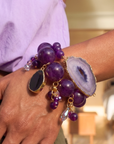 Three piece stretch bracelet stack featuring genuine purple agate beads, a natural druzy agate slice, crystal charms, gemstone accents, and gold detailing.