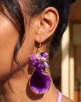 Statement dangle earrings featuring genuine purple agate slices, grape agate beads, faceted crystal accents, and gold detailing.