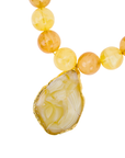 Yellow and cream marbled statement necklace featuring oversized citrus-toned beads and a natural agate pendant with gold trim by Sassy Jones.