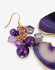 Chrysallis Natural Purple Agate dangle earrings featuring polished agate slice drops, clustered purple faceted beads and gold tone fish hook closures.