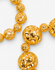Dina Gold Openwork Sculptural Sphere 2 Piece Stretch Bracelet Stack featuring oversized and petite gold globes.