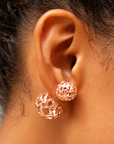 Dina Sculptural Globe Double Studs Rose Gold featuring two openwork spheres in contrasting sizes.