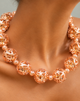 Dina Sculptural Globe Chain Rose Gold featuring oversized openwork sphere beads and smaller textured spacers.