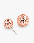 Rose gold statement earrings featuring a petite textured sphere and larger sculptural globe.