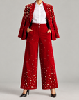 Womens high-waisted red velvet pants featuring dimensional pearl embellishments and tailored front pleating.