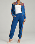 Womens embellished denim pants featuring jewel detailing down the legs and a comfortable jogger silhouette.