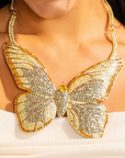 Gold butterfly statement bib necklace with champagne and clear crystals in a radiant oversized design.