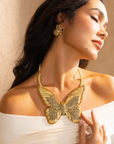 Gold butterfly statement bib necklace with champagne and clear crystals in a radiant oversized design.