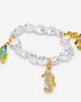 Coastal statement bracelet set featuring luminous pearl strands, seahorse, fish and anchor charms with gold accents.