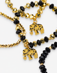 Ibiza 4pc Stretch Bracelet Stack in Black and Gold featuring faceted beads and elephant charms.