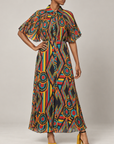 Imani Pleated Flowy Dress - Afrikaan featuring a colorful geometric print, cape sleeves, collared neckline, and flowing maxi skirt.