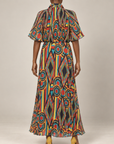 Multicolor printed maxi dress featuring cape inspired short sleeves, a fitted waist, and lightweight flowing construction.