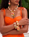 Kalani tropical parrot three piece stretch bracelet stack featuring luminous pearls, colorful beads, ornate gold tone accents and a floral parrot charm.