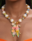 Kalani Pearl Chain necklace featuring oversized pearls, colorful floral beads, gold tone details and a hand painted tropical parrot pendant surrounded by flowers.