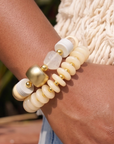 Kamaria Ivory Coast hoop earrings featuring sculptural ivory coconut shell discs with gold colored bead accents.