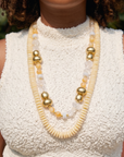Ivory statement necklace featuring layered coconut shell discs, clear natural stone beads and 18k gold plated accents.