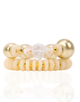 Two-piece ivory stretch bracelet stack featuring coconut-inspired beads, brushed gold accents, frosted white details, and a faceted clear focal bead.