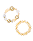 Two-piece ivory stretch bracelet stack featuring coconut-inspired beads, brushed gold accents, frosted white details, and a faceted clear focal bead.