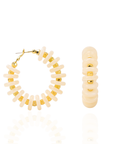 Ivory statement hoop earrings featuring smooth coconut-inspired beads with brushed gold spacers in a lightweight resort-inspired design.