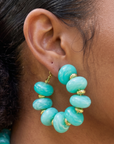 Teal statement hoop earrings featuring oversized marbled turquoise beads and gold-tone accents by Sassy Jones.