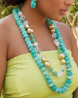 Layered teal statement necklace featuring marbled turquoise beads, frosted sea-glass inspired accents, and gold-tone details by Sassy Jones.