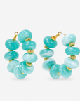 Kamaria Coconut Shell Statement Hoops in Riviera Teal featuring oversized marbled teal coconut shell pieces and gold accents.