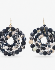 Kenza Cloth Bead Dangle Earrings in black and white featuring layered circular rows of fabric wrapped beads.