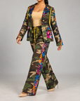 Women's statement camo pants featuring functional pockets, wide legs and multicolor sequin embellishment.