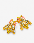 Miss Beasley Crystallique statement earrings shown on ear with sparkling wings and pastel accents.