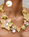 Women's statement necklace featuring oversized crystal florals in blush pink, green and yellow with jeweled insect details.