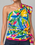Mediterranean inspired statement scarf featuring a floral garden scene framed by leafy branches, citrus fruit and a bright pink border.
