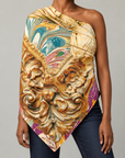 Close up of Nika Regal Portrait Scarf showcasing intricate gold scrollwork and swirling teal, plum and champagne artwork.