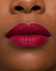 Bold red lipstick in gold tube with vibrant red swatch for a powerful statement lip look.