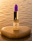 Bold violet lipstick in gold tube with vibrant purple swatch for a high impact statement lip.