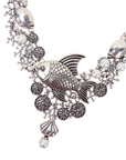 Antiqued silver statement necklace featuring sculpted fish, coral inspired branches, luminous pearl accents, shell details, and intricate ocean textures.