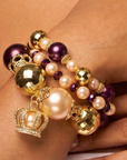 Purple and champagne pearl bracelet stack featuring three coordinating stretch bracelet designs.