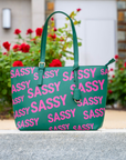 Pretty In The City promotional bundle featuring the Pink & Green Sassy City Tote, Maverick Lip Liner, Off Black Sculpt & Serve Brow Pencil, Confidence Card Stack, and Roxie Radiance Cuff by Sassy Jones.