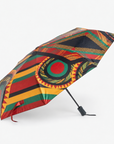 Afrikaan Umbrella displayed open with a compact black handle and vibrant geometric print.